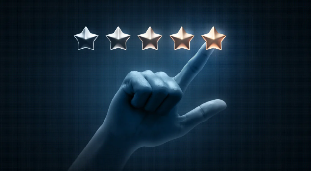 Hand selecting the fifth gold star in a 5-star rating